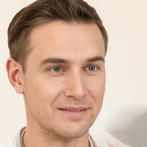 Joyful white adult male with short  brown hair and grey eyes