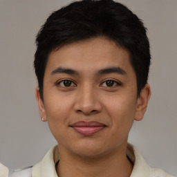 Joyful latino young-adult male with short  black hair and brown eyes