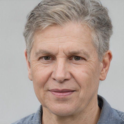 Joyful white middle-aged male with short  gray hair and grey eyes