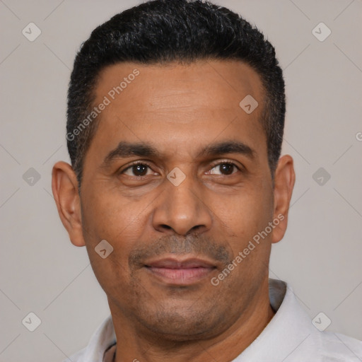 Joyful latino adult male with short  black hair and brown eyes