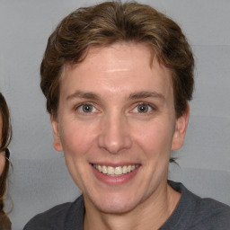 Joyful white adult female with short  brown hair and brown eyes