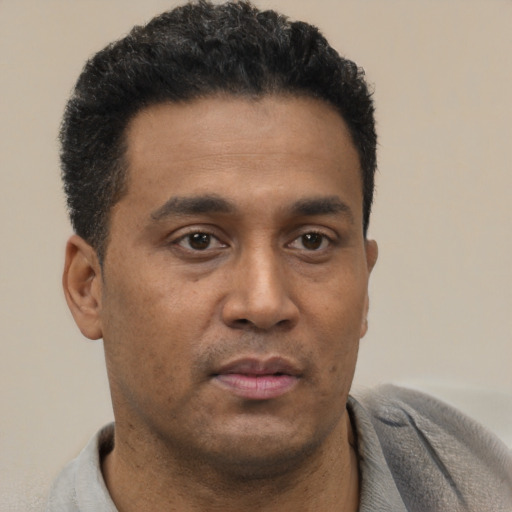 Neutral black young-adult male with short  brown hair and brown eyes