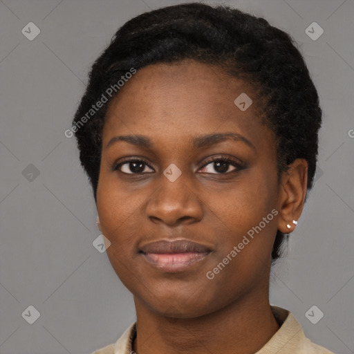 Joyful black young-adult female with short  black hair and brown eyes