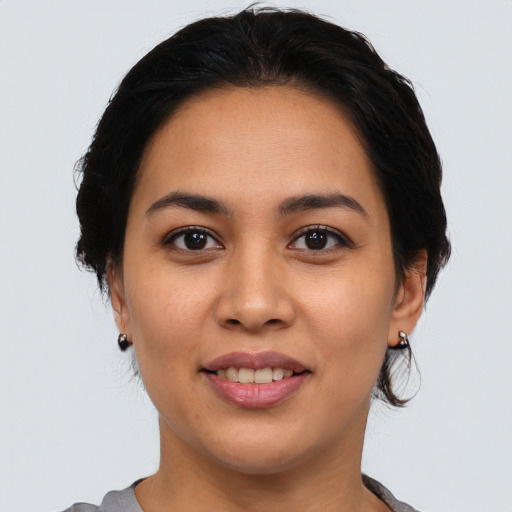 Joyful latino young-adult female with medium  black hair and brown eyes