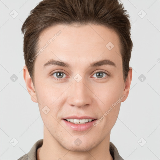 Joyful white young-adult male with short  brown hair and grey eyes