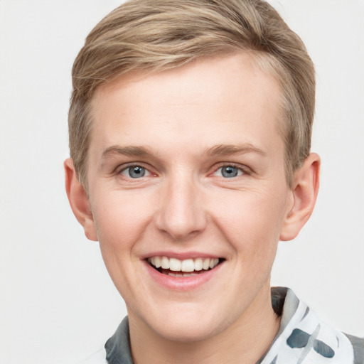 Joyful white young-adult male with short  brown hair and blue eyes