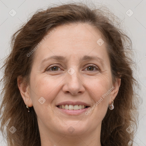 Joyful white adult female with long  brown hair and grey eyes