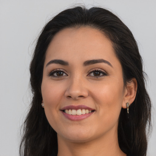 Joyful latino young-adult female with long  brown hair and brown eyes