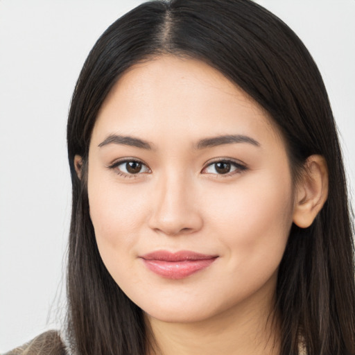 Joyful asian young-adult female with long  brown hair and brown eyes