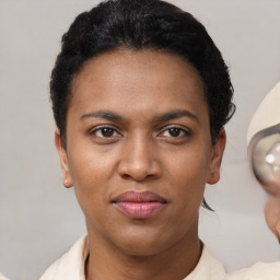 Joyful latino young-adult female with short  brown hair and brown eyes