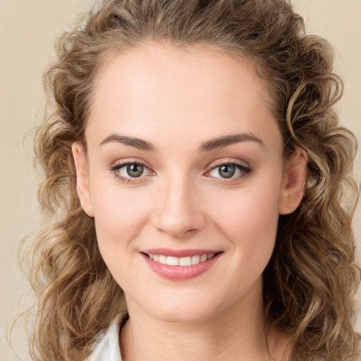 Joyful white young-adult female with medium  brown hair and green eyes