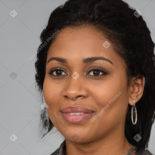 Joyful black young-adult female with long  black hair and brown eyes