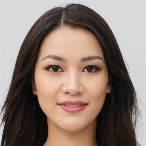 Joyful asian young-adult female with long  brown hair and brown eyes