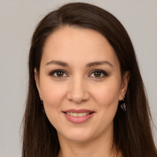 Joyful white young-adult female with long  brown hair and brown eyes