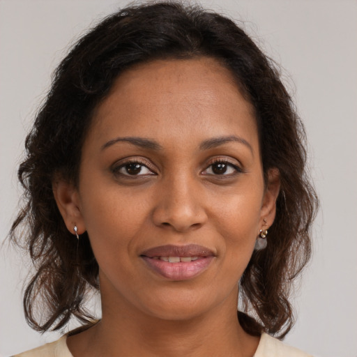Joyful black young-adult female with medium  brown hair and brown eyes