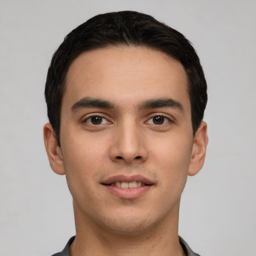 Joyful white young-adult male with short  black hair and brown eyes