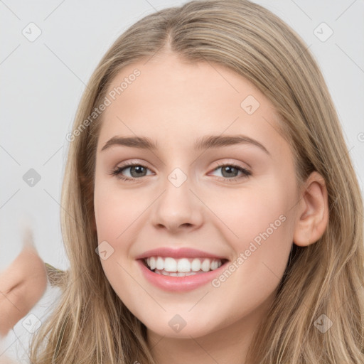 Joyful white young-adult female with long  brown hair and grey eyes