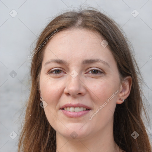 Joyful white adult female with long  brown hair and grey eyes