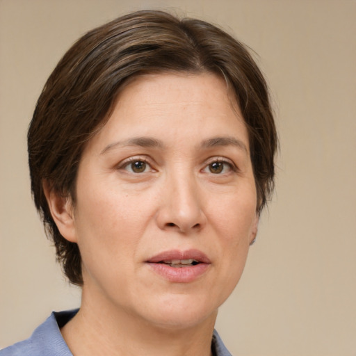 Joyful white adult female with medium  brown hair and brown eyes