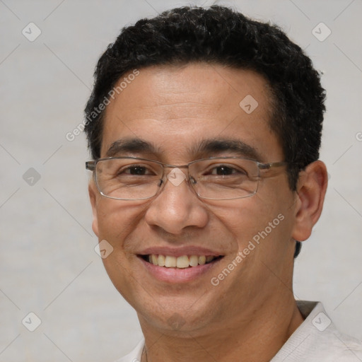 Joyful white adult male with short  black hair and brown eyes