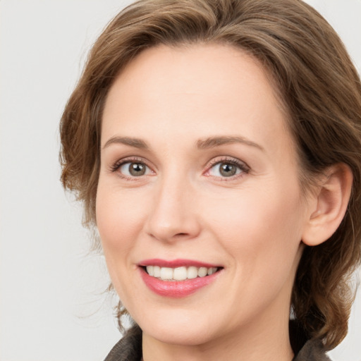 Joyful white adult female with medium  brown hair and blue eyes