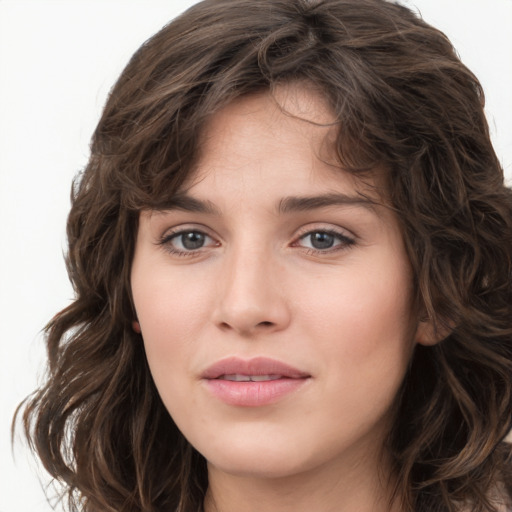 Joyful white young-adult female with long  brown hair and green eyes