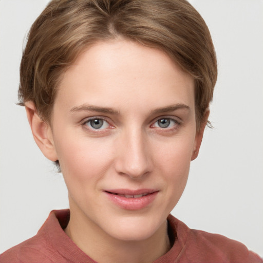 Joyful white young-adult female with short  brown hair and grey eyes