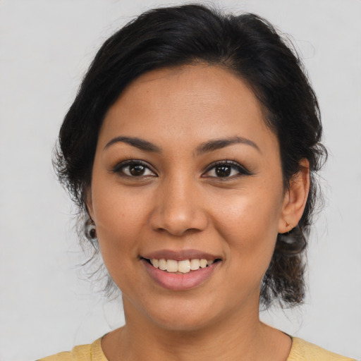 Joyful latino young-adult female with medium  brown hair and brown eyes