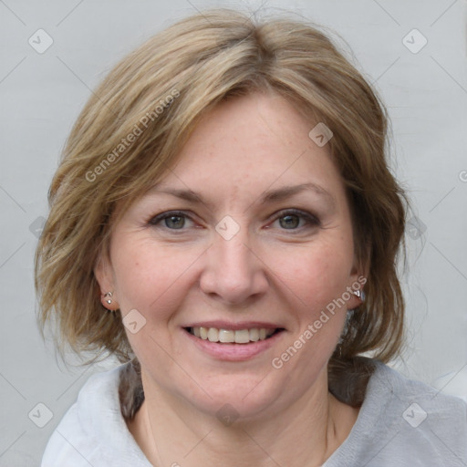 Joyful white young-adult female with medium  brown hair and blue eyes