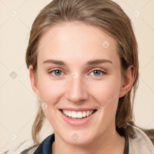 Joyful white young-adult female with medium  brown hair and grey eyes