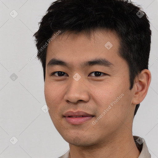 Joyful asian young-adult male with short  black hair and brown eyes