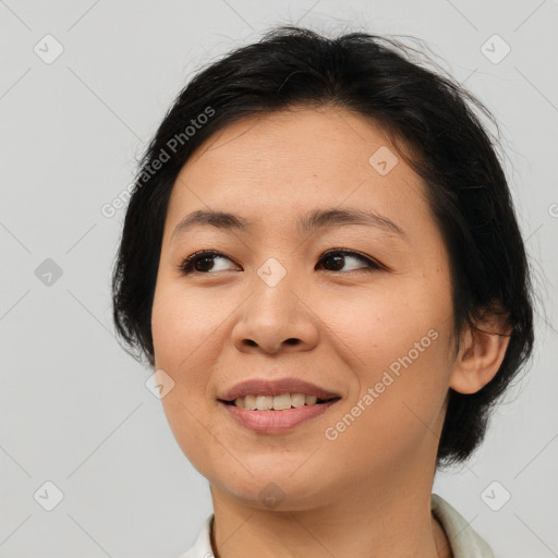 Joyful asian young-adult female with medium  brown hair and brown eyes