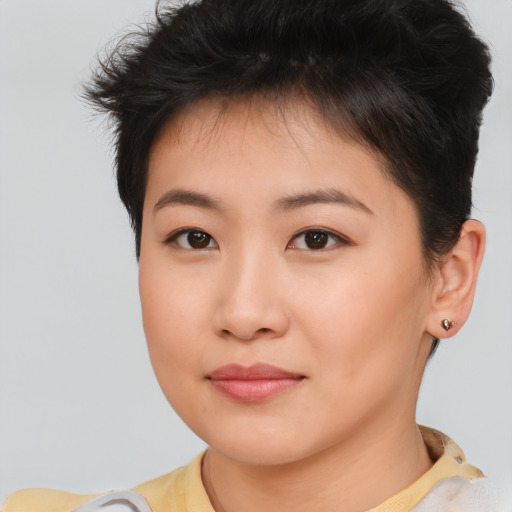 Joyful asian young-adult female with short  brown hair and brown eyes