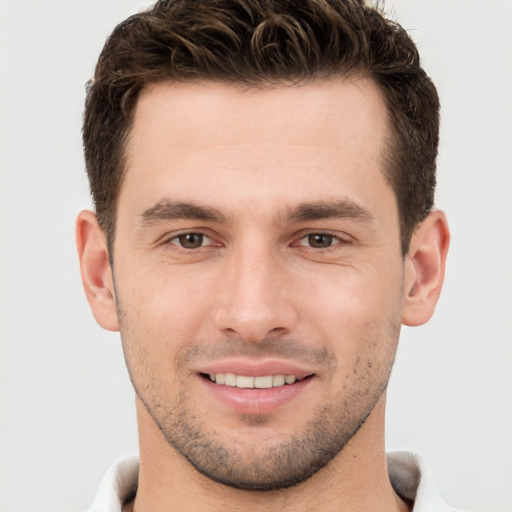 Joyful white young-adult male with short  brown hair and brown eyes