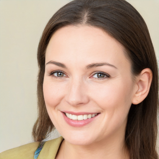 Joyful white young-adult female with long  brown hair and brown eyes