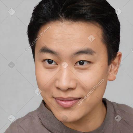 Joyful asian young-adult male with short  brown hair and brown eyes