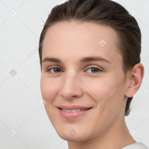 Joyful white young-adult female with short  brown hair and grey eyes