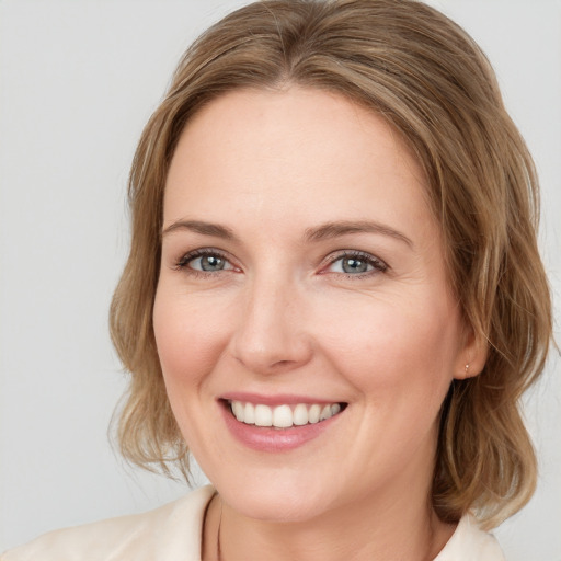 Joyful white young-adult female with medium  brown hair and blue eyes