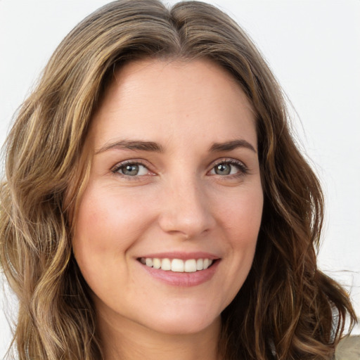 Joyful white young-adult female with long  brown hair and green eyes