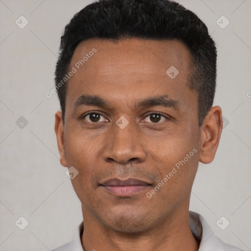 Joyful black adult male with short  black hair and brown eyes