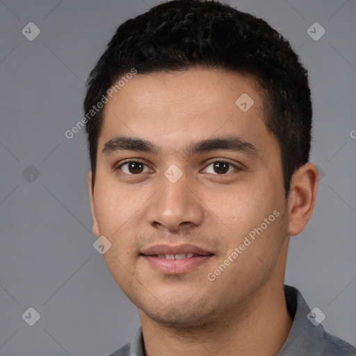 Joyful latino young-adult male with short  black hair and brown eyes