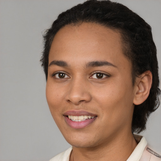 Joyful latino young-adult female with short  black hair and brown eyes