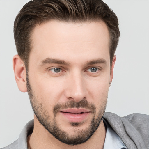 Joyful white young-adult male with short  brown hair and brown eyes