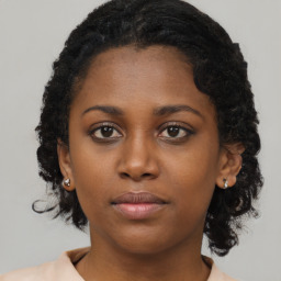 Neutral black young-adult female with medium  brown hair and brown eyes