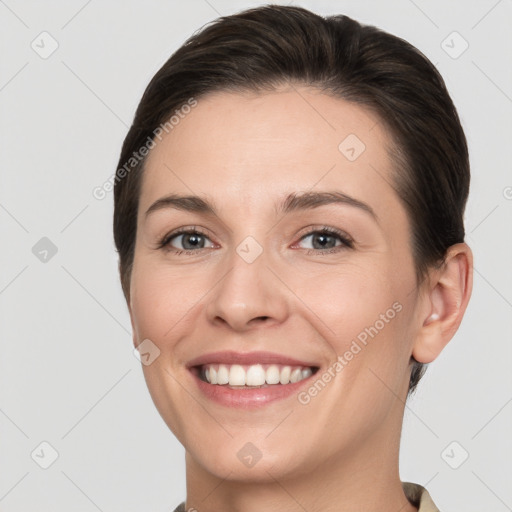 Joyful white young-adult female with short  brown hair and grey eyes