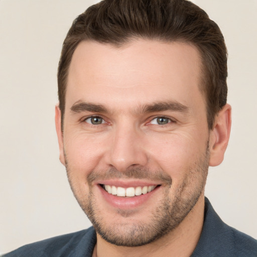 Joyful white young-adult male with short  brown hair and brown eyes