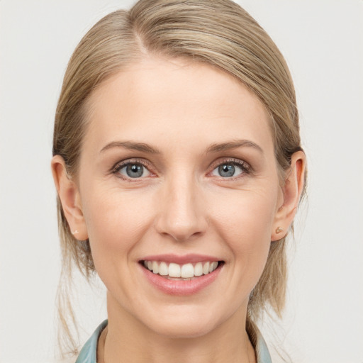 Joyful white young-adult female with medium  brown hair and blue eyes