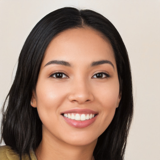 Joyful latino young-adult female with long  black hair and brown eyes