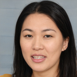 Joyful asian young-adult female with long  brown hair and brown eyes