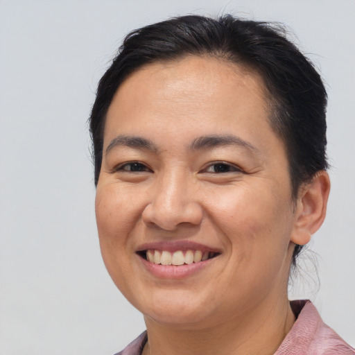 Joyful asian young-adult female with medium  brown hair and brown eyes